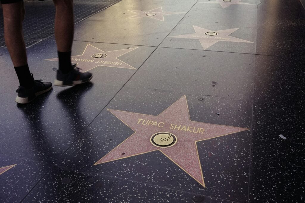 Hollywood. Photo of Hollywood Walk of Fame stars including famous names on a sidewalk.