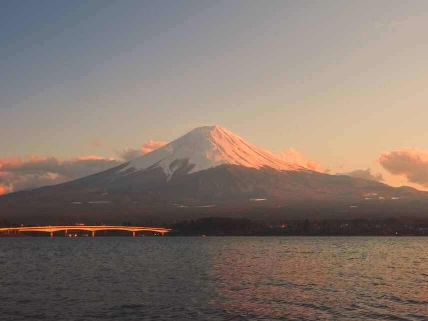 a large body of water with a mountain in the background
